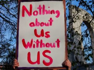 "Nothing about Us Without US" Sign
